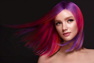 Portrait of beautiful woman with multi-colored hair and creative make up and hairstyle