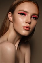 Portrait of a beautiful woman with pink creative make up. Beauty face. Photos shot in studio