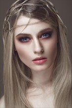 Beautiful fashion woman with creative make-up and hairstyle. The beauty of the face. Photos shot in the studio