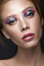 Beautiful girl with creative colorful makeup. Beauty face. Photos shot in studio