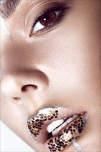 Portrait of a Beautiful fashionable girl with a creative glitter make-up and sparkles on the lips. Close up beauty face. Photos shot in studio