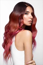 Beautiful pink-haired girl in move with a perfectly curls hair