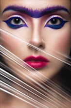Fashion model with bright make-up art with a solid eyebrow. Creative image. Picture taken in the studio