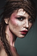 Beautiful strange girl with creative art make-up. Beauty face. Photo taken in studio