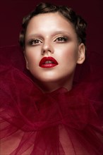 Beautiful girl with art creative make-up in the image of a red bride for Halloween. Beauty face. Photo taken in studio