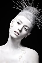 Art fashion girl with white skin and unusual hairstyle. Creative art beauty. Picture taken in the studio on a black background