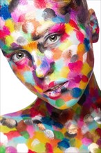 Girl with colored face painted. Art beauty image. Picture taken in the studio on a white background