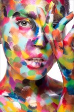 Girl with colored face painted. Art beauty image. Picture taken in the studio on a white background