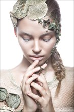 Beautiful fashionable girl in image of sea fairies with shells and algae on the face. Art beauty face. Picture taken in the studio
