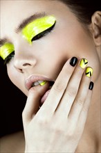 Close-up portrait of girl with yellow and black make-up