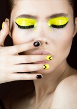 Close-up portrait of girl with yellow and black make-up