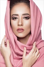 Beautiful girl in the Arab scarf with oriental make-up. Beauty face. Photos shot in the studio