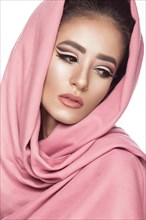 Beautiful girl in the Arab scarf with oriental make-up. Beauty face. Photos shot in the studio