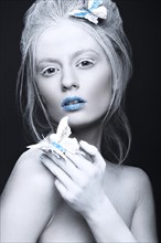 Portrait of a beautiful woman in an unusual winter look with blue lips. Creative make up. Art look. Photo taken in studio