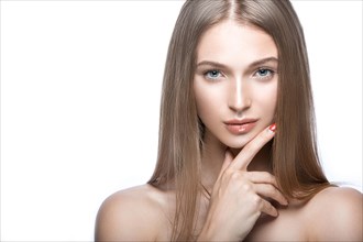 Beautiful young girl with a light natural make-up. Beauty face. Picture taken in the studio on a white background