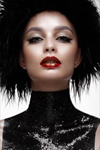 Beautiful fashion woman with creative make-up and black wig. The beauty of the face. Photos shot in the studio