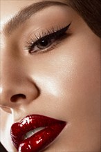 Beautiful makeup in Hollywood image with red lips. Close up beauty face. Photo taken in the studio