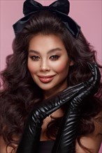 Beautiful Asian brunette model looks like a doll: with volume curls