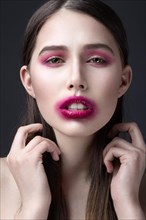 Girl with pink lipstick smeared across his face. Creative makeup. Picture taken in the studio