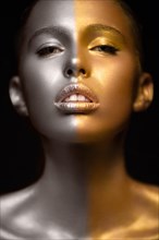 Beautyful girl with gold glitter on her face.Art image beauty face. Picture taken in the studio on a black background