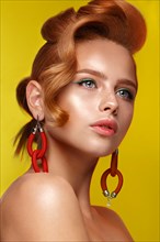 Beautiful girl with unusual accessories and make-up on a bright background. Beauty face. Photo taken in the studio
