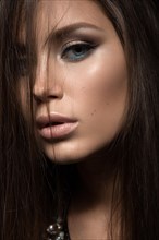 Beautiful woman with evening make-up and long straight hair