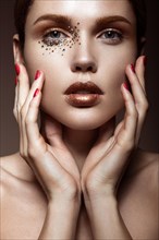 Beautiful girl with a gentle make-up and crystals on the face. Beauty face. Picture taken in the studio