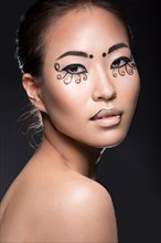 Beautiful Asian girl with a creative makeup