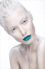 Beautiful girl in the image of albino with blue lips and white eyes. Art beauty face. Picture taken in the studio on a white background