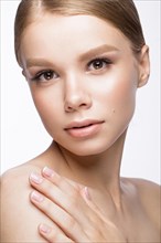 Beautiful young girl with a light natural make-up and French manicure. Beauty face. Picture taken in the studio on a white background