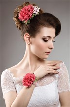 Portrait of a beautiful woman in the image of the bride with flowers in her hair. Picture taken in the studio on a black background