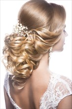 Portrait of a beautiful woman in image of the bride. Picture taken in the studio on a black background. Beauty hair. Hairstyle back view