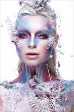 Beautiful girl in the image of a snowy unicorn creature. Creative make up. Art looks. Photo taken in the studio