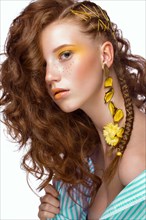 Portrait of beautiful red-haired girl with brightly colored art makeup and curls. Beauty face. Photo taken in the studio