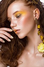 Portrait of beautiful red-haired girl with brightly colored art makeup and curls. Beauty face. Photo taken in the studio