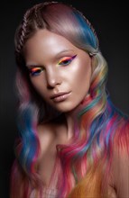Beautiful girl with multi-colored hair and creative make-up and hairstyle. Beauty face. Photo taken in the studio