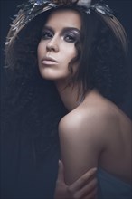 Beautiful girl in a light blue dress and long hair in a fashionable image. Beauty fashion style. Picture taken in the studio with mixed light