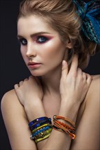 Beautiful fashion girl in a scarf and bracelets boho style. Beauty face