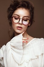 Beautiful girl in stylish clothes with glasses for vision. Beauty face. Photo taken in the studio