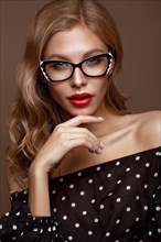 Beautiful girl in stylish clothes with glasses for vision and red sexy lips. Beauty face. Photo taken in the studio