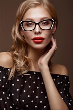 Beautiful girl in stylish clothes with glasses for vision and red sexy lips. Beauty face. Photo taken in the studio