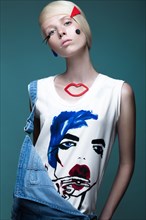 Fashionable girl with natural make-up in clothes with a picture in the style of pop art