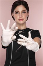 Manicurist in working form with tools in hand. Nail photo content