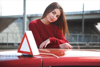 Young beautiful happy woman posing near training car