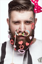 Funny bearded man with hearts Valentine's Day. Portrait shot in studio