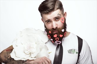 Funny bearded man with hearts Valentine's Day. Portrait shot in studio