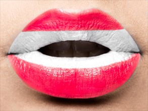 Female lips close up with a picture of the flag of Austria. white