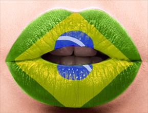 Female lips close up with a picture of the flag of Brazil. green