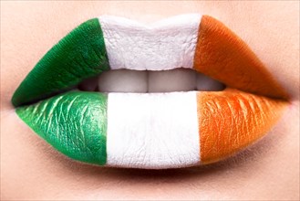Female lips close up with a picture flag of Ireland. Green