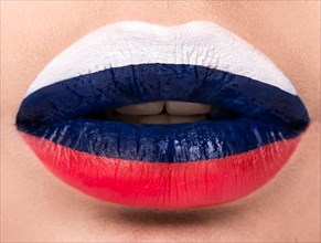 Female lips close up with a picture of the flag of Germany. black